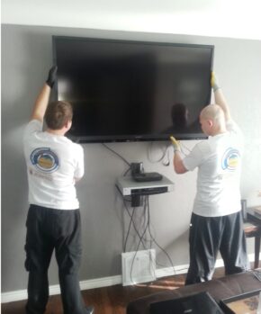 movers installing a tv