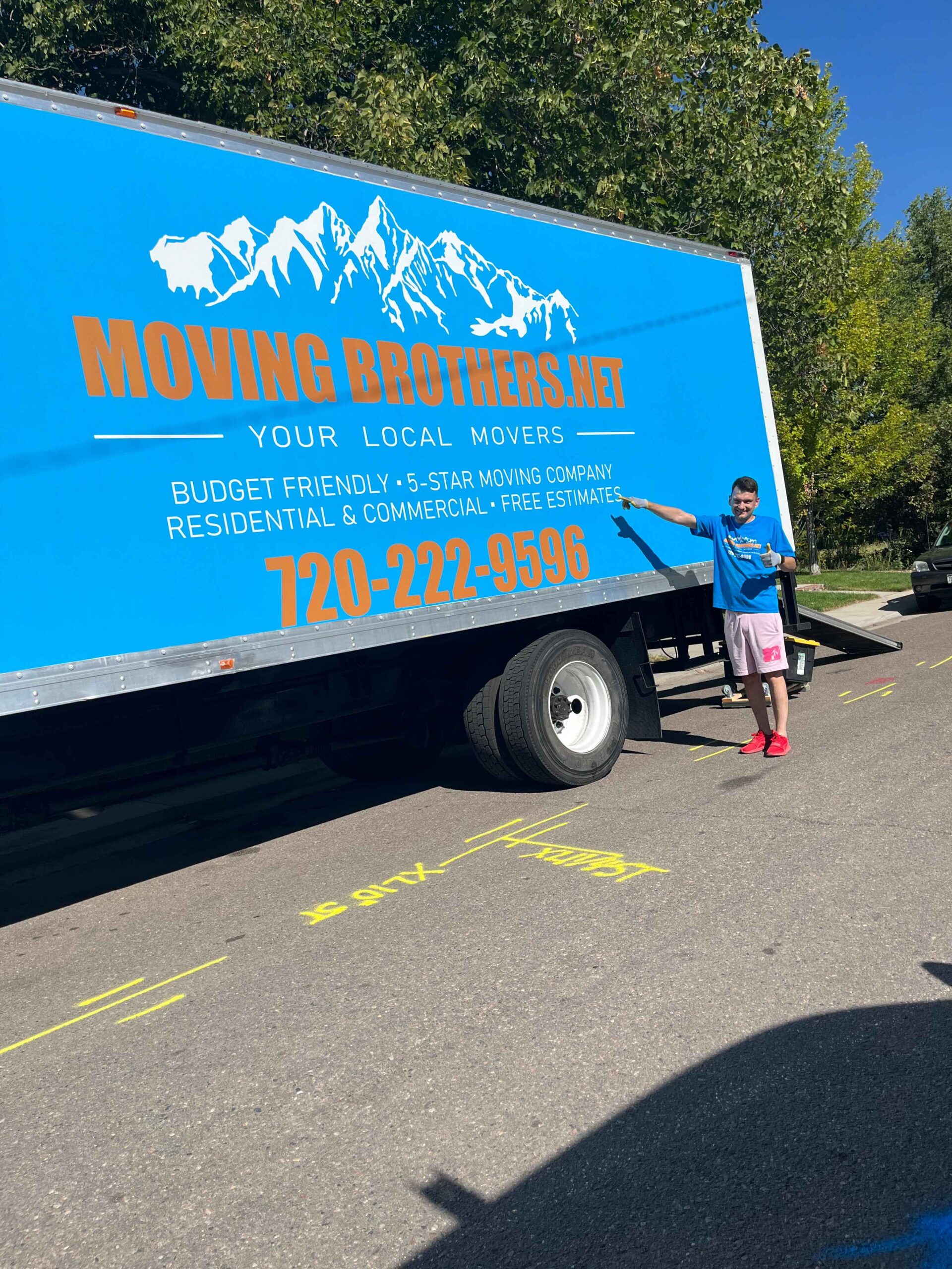 A mover pointing at the Moving Brothers truck